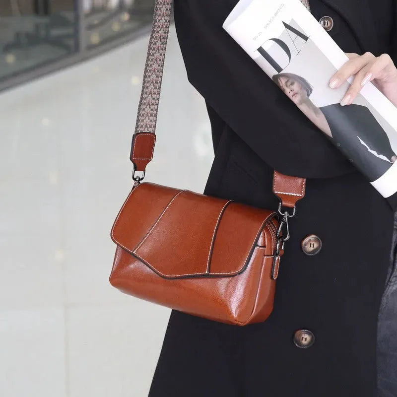Top grain leather crossbody bag in caramel colour with zip closure and patchwork design