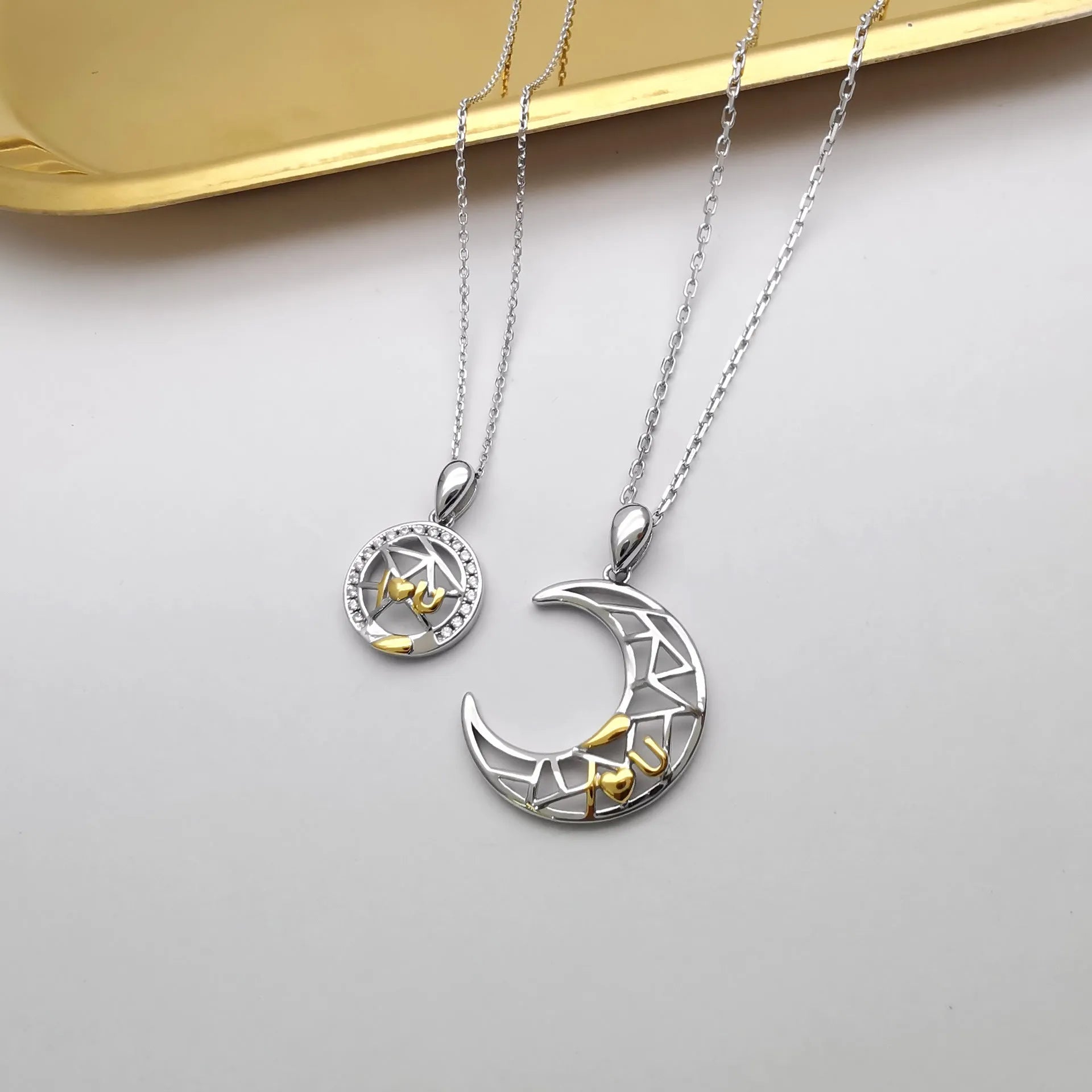 Sun moon tooth couple necklace with copper pendant on a cross chain, showing male and female colour variants.
