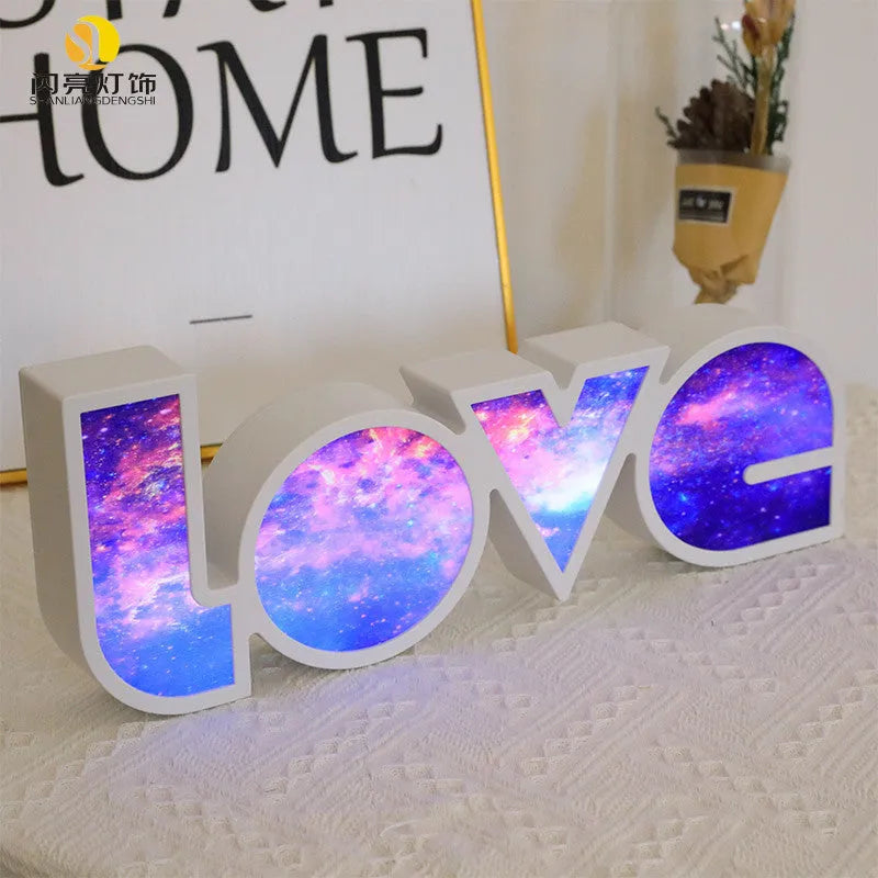 Rainbow style LED LOVE decorative table lamp with plastic shade on a table