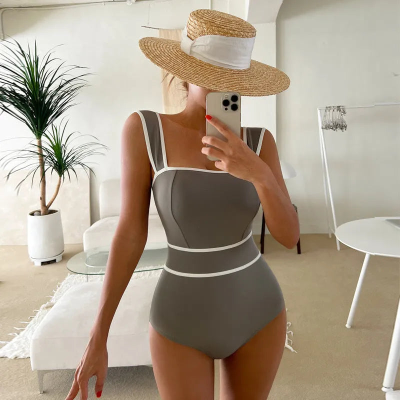 Women's white one-piece swimsuit with lace-up back design on mannequin