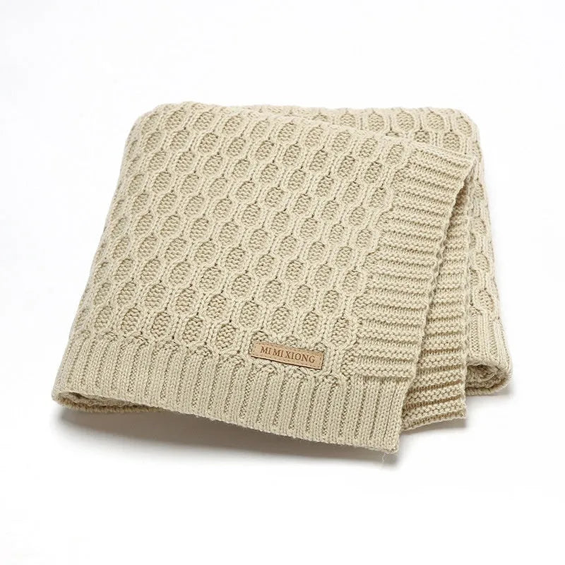 Solid colour infant blanket with raised line texture in beige khaki, laid flat showing 70x90cm size.