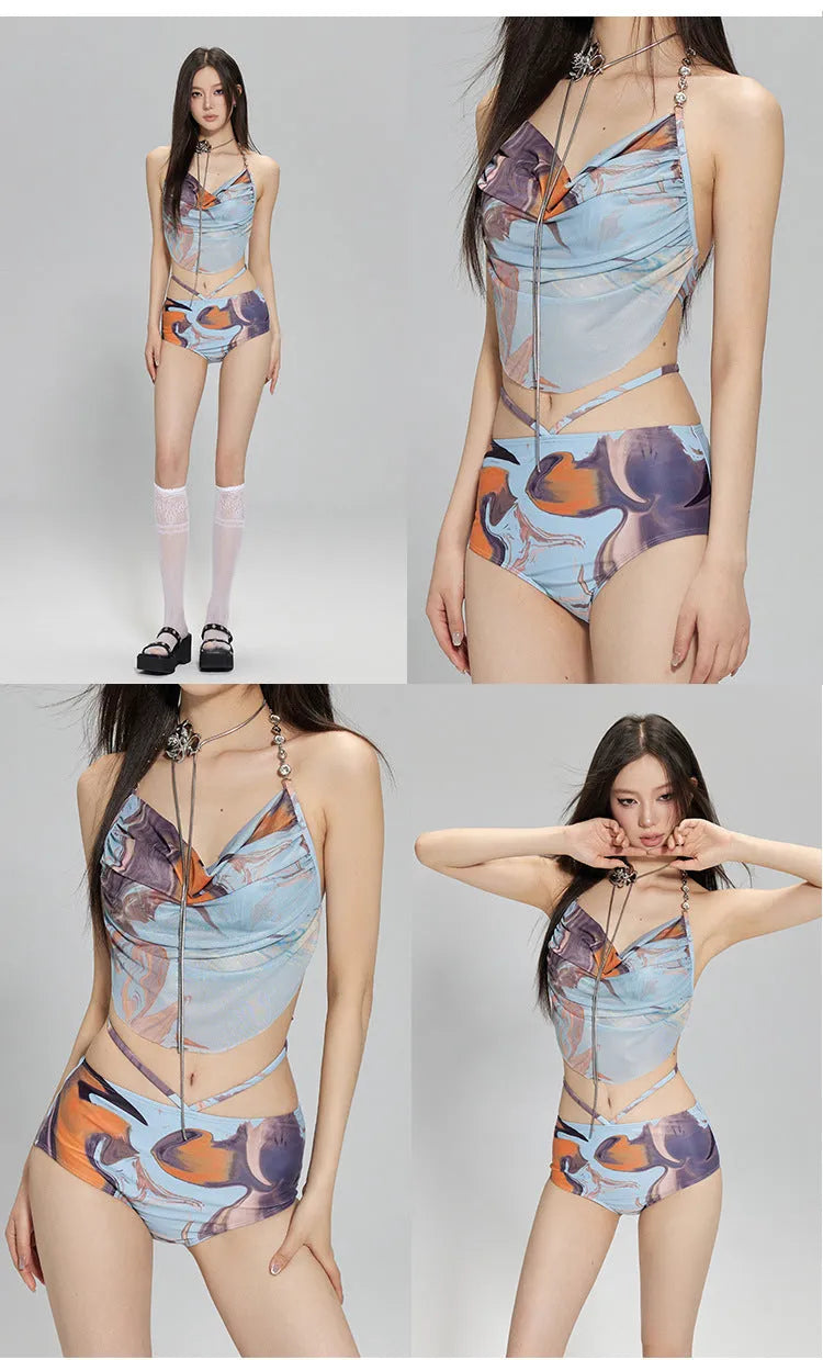 Women's blue printed bikini set with triangle top, bikini pants, and matching skirt laid flat.
