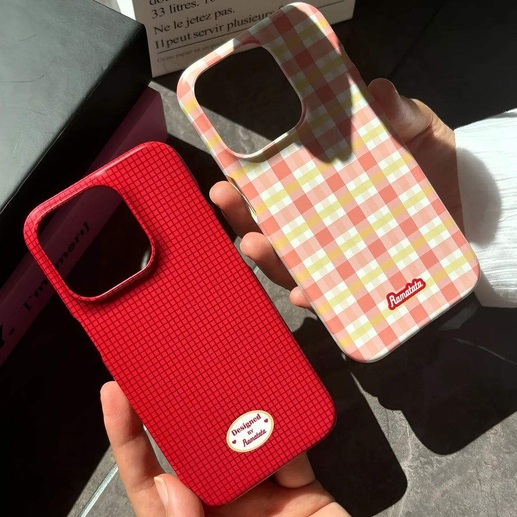 iPhone 15 Pro Max phone case with red and orange plaid design on glossy and frosted feilin shells.