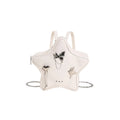 Women's soft black PU leather mini messenger backpack worn crossbody.