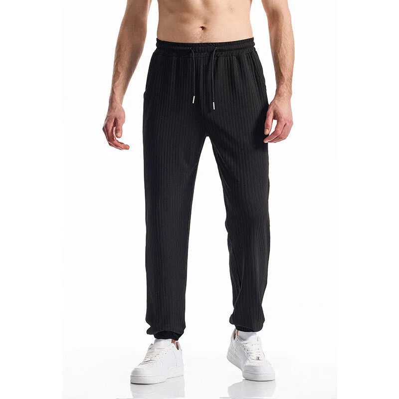 Men's black silky rib fabric casual trousers with baggy straight leg and elastic waistband