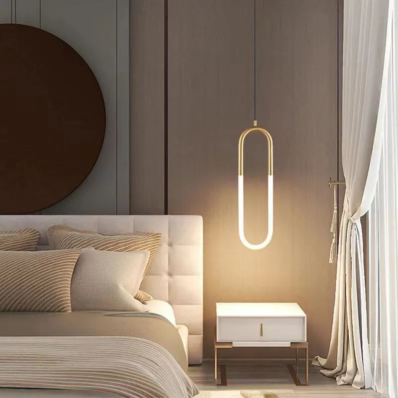 Nordic minimalist U-shaped bedside chandelier with a white shade on a pendant cord.