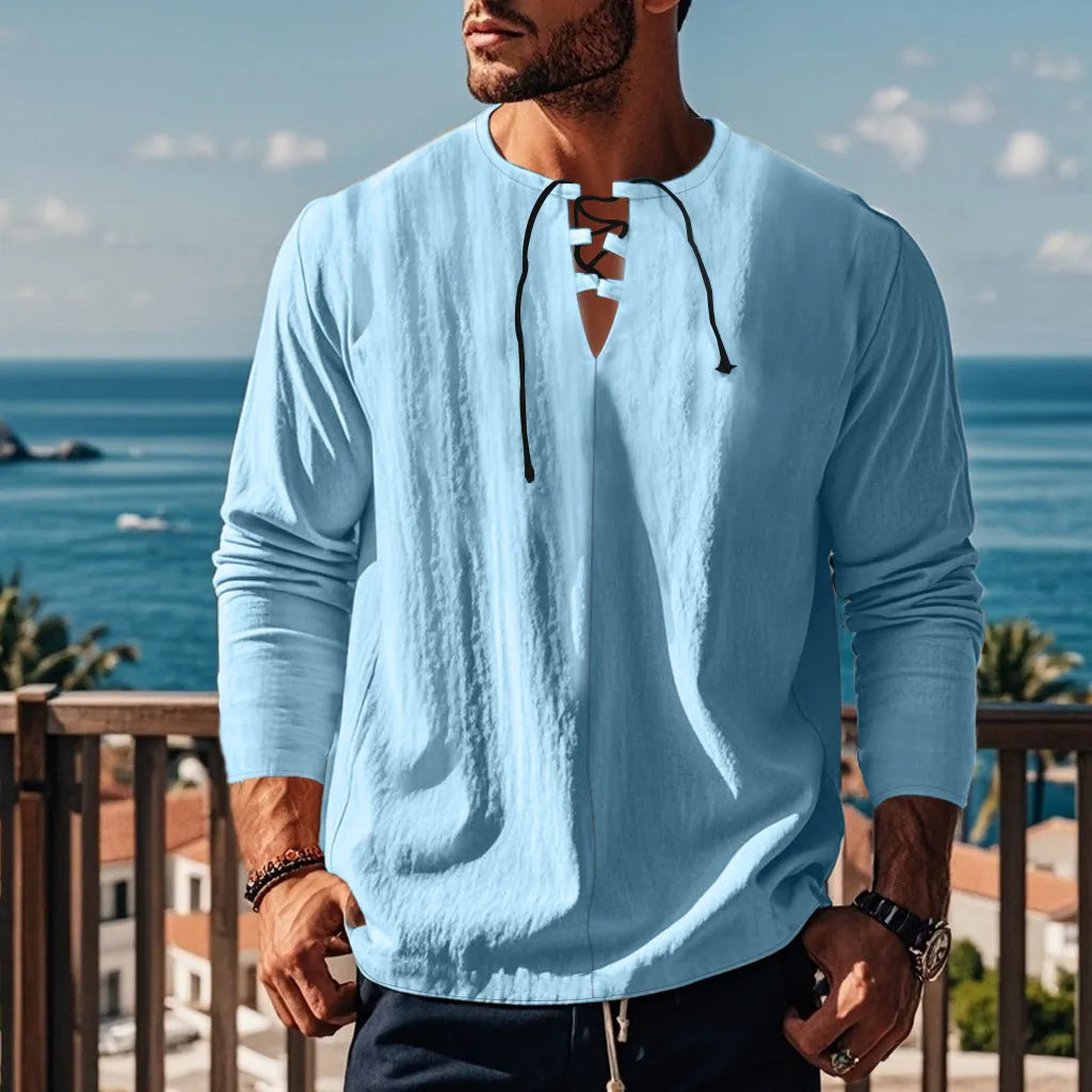 Man wearing a loose fit solid colour cotton linen beach shirt in a casual setting.