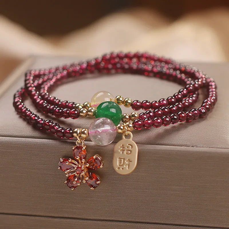 Women's crystal pomegranate bracelet with red cherry blossom beads and sequin detailing