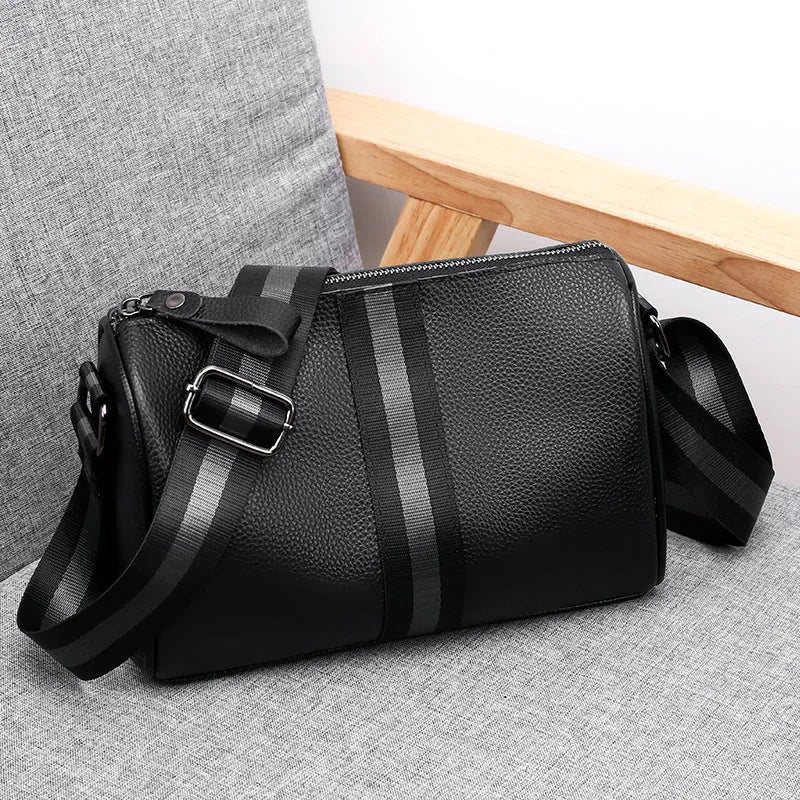Black genuine leather crossbody bag showing adjustable strap and main compartment
