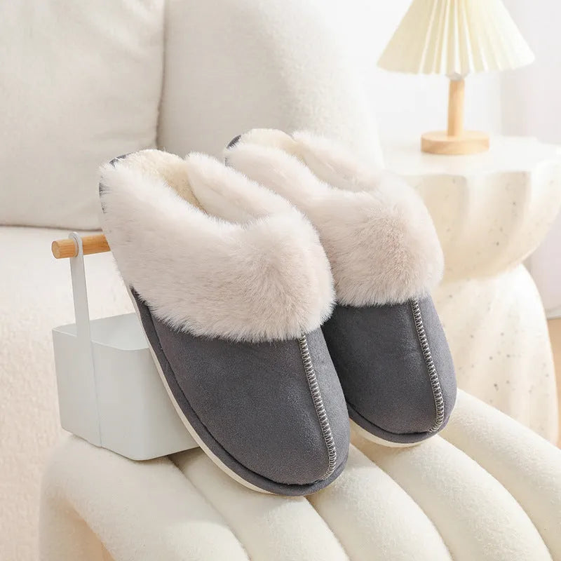 Brown plush indoor slippers with round toe, flat heel, and stitched detail on a PVC sole.