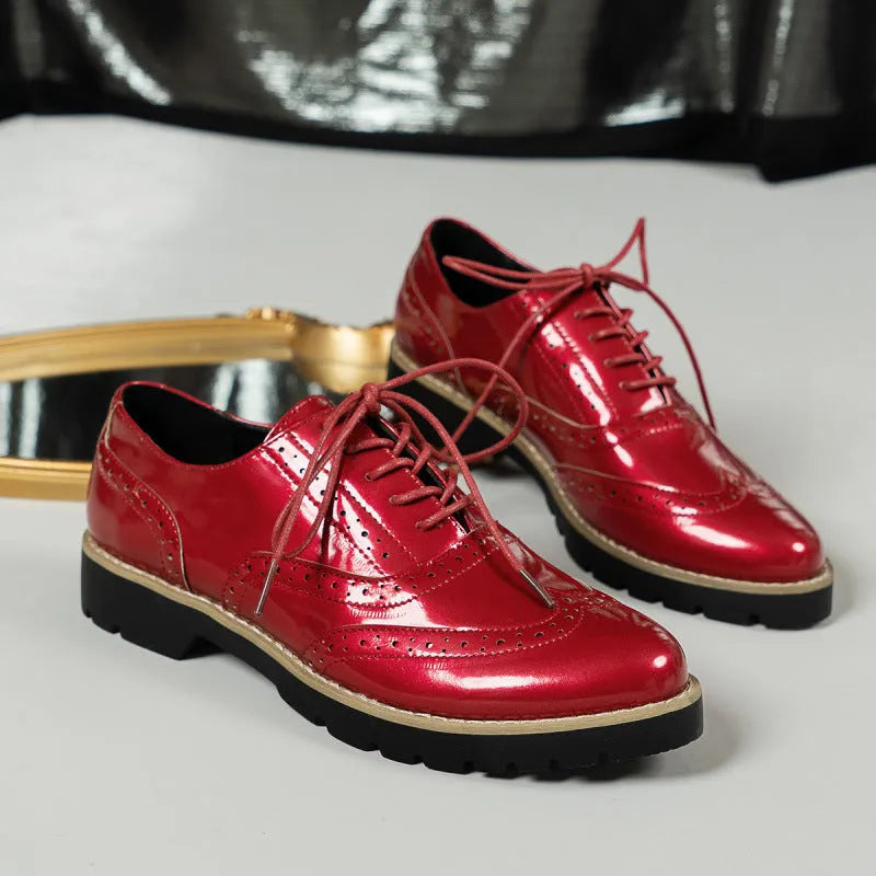 Women's black oxford shoes with wedge heel and sequin detailing, showing round toe and middle mouth cut