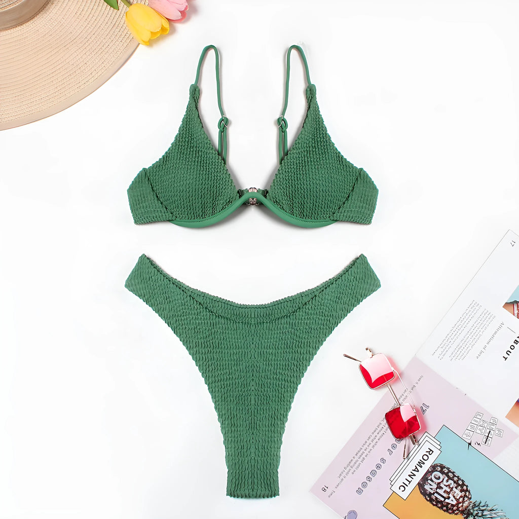 Women's solid green bikini suit with ruffle detailing and split-front design on mannequin