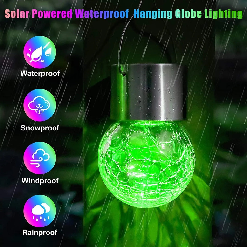 Outdoor solar glass ball chandelier with LED light in a garden setting, showing colourful lighting option