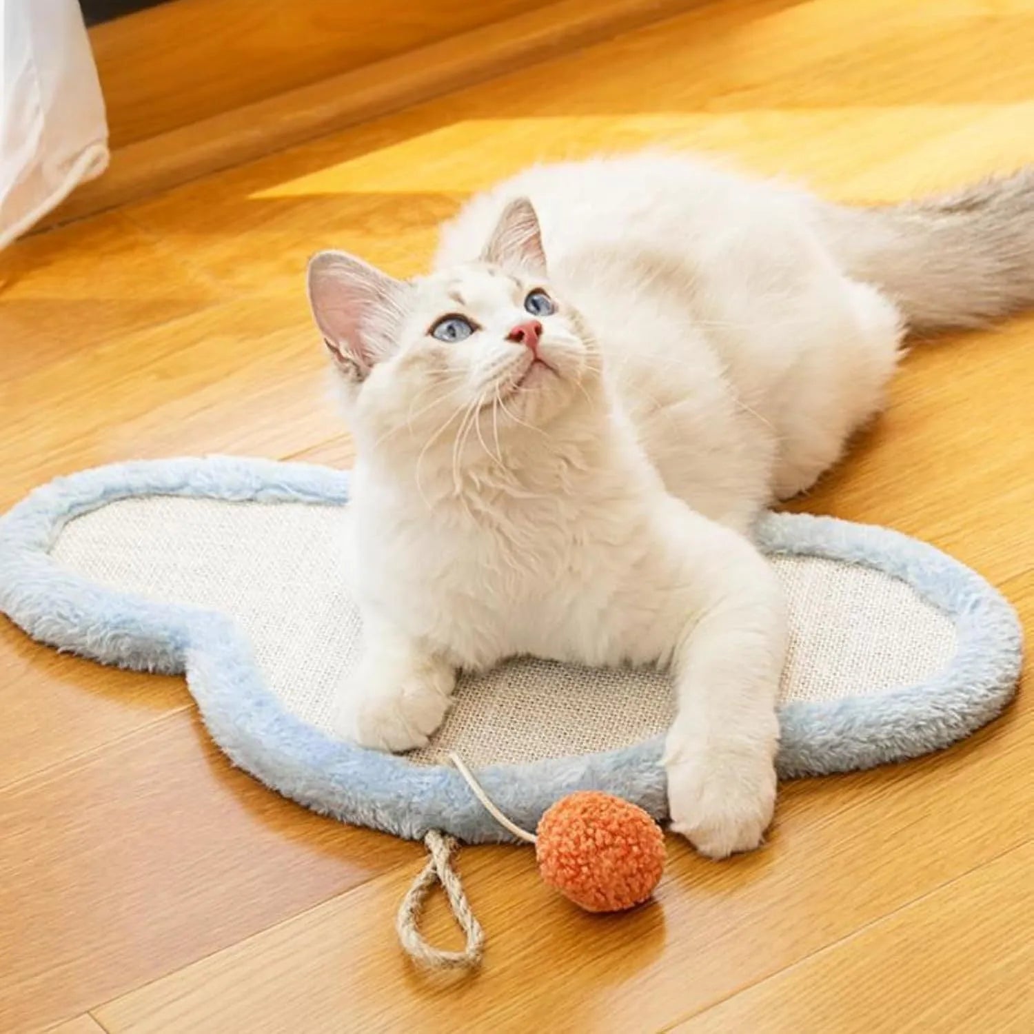 White cat scratching mat with cartoon sleeping cat design, made from natural sisal, shown on a wall.