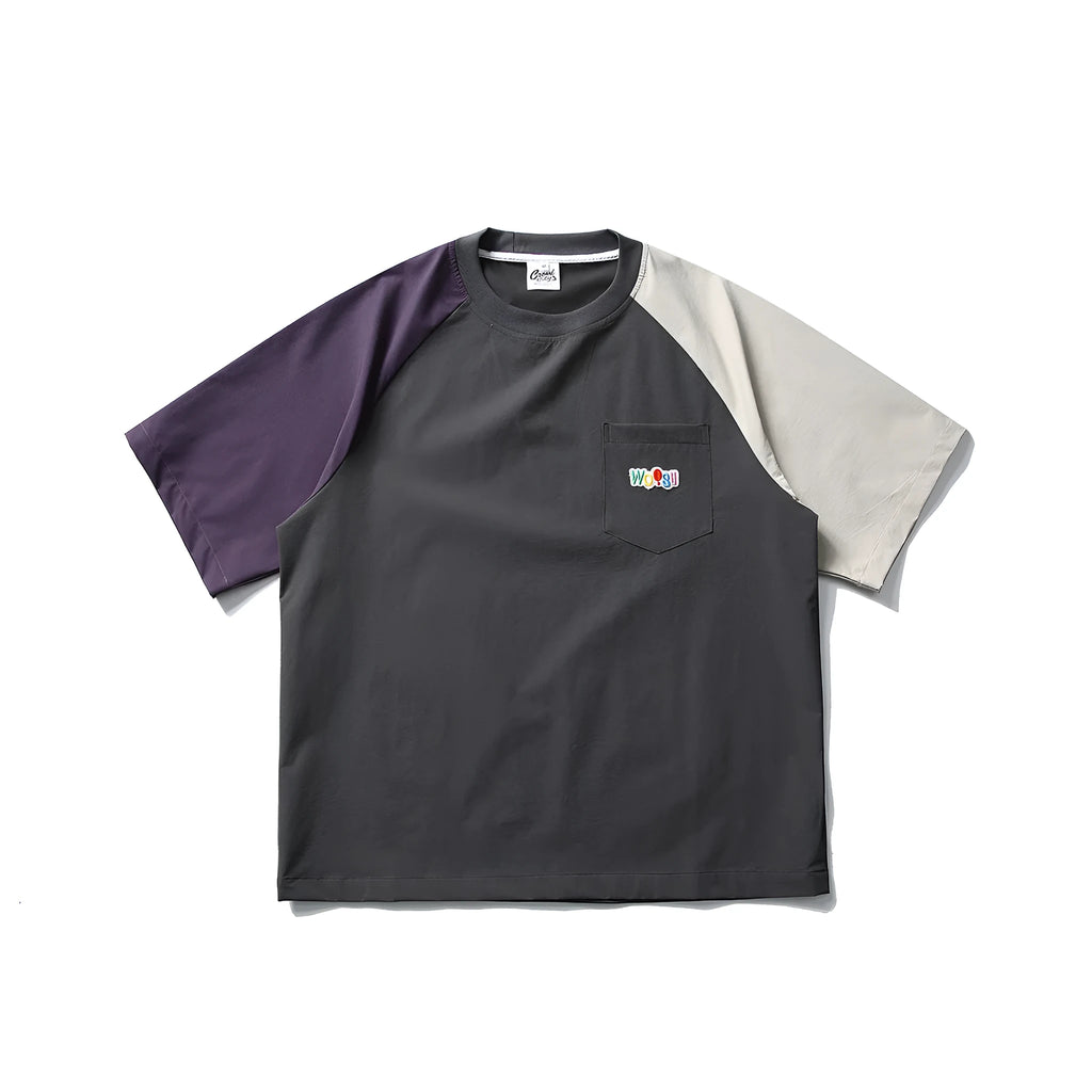 Dark grey loose fit t-shirt with contrast colour raglan sleeves on a hanger.