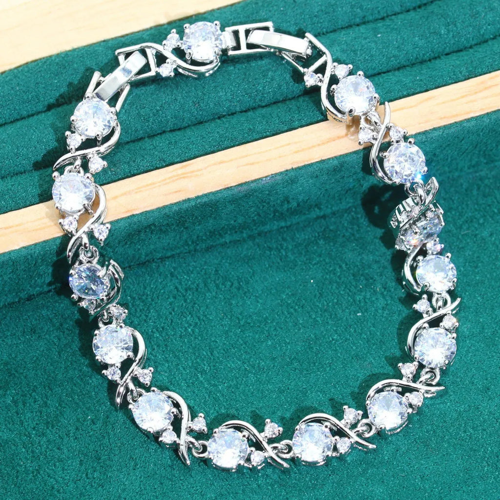 Bridal zircon alloy jewellery four-piece set showing necklace, earrings, ring and bracelet on water wave chain