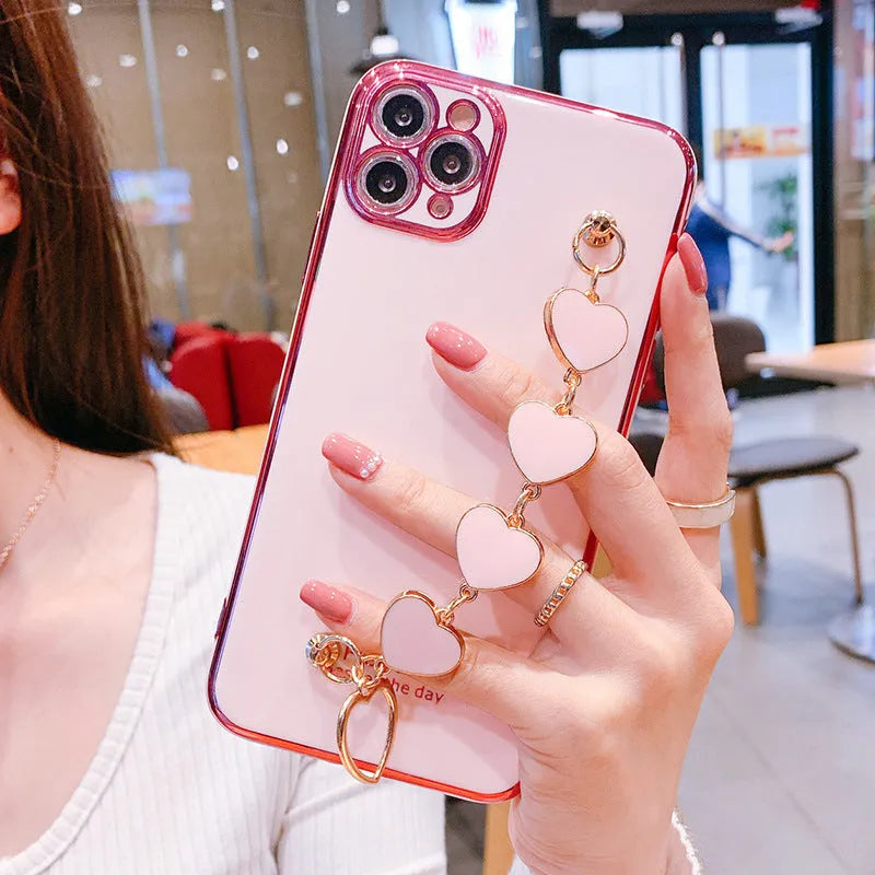 Silicone phone case with wrist bracelet for Samsung smartphones in solid green, pink, purple, or light green.