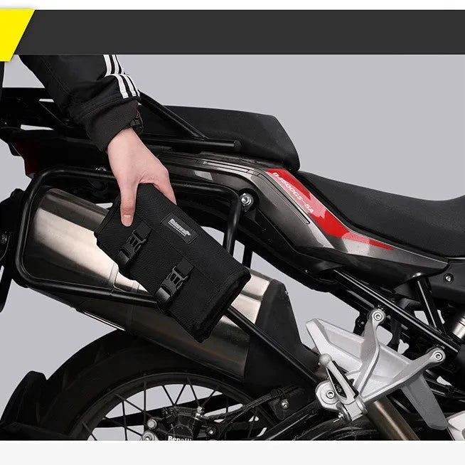 Motorcycle repair tool roll laid flat in black polyester with elastic straps and mesh zipper pocket