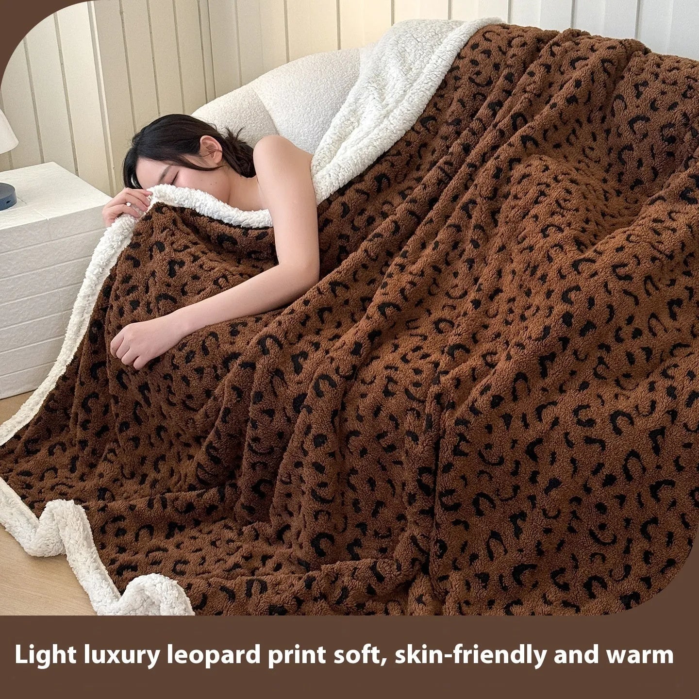 Double-layer taffeta blanket with woven leopard print pattern draped over sofa
