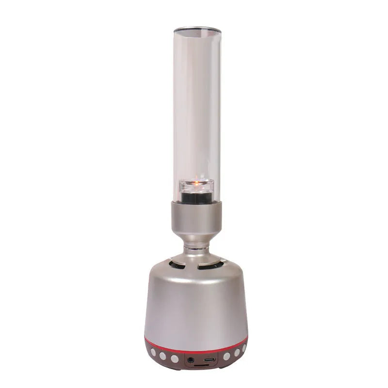 White silver candlelight Bluetooth speaker and night light on a table.