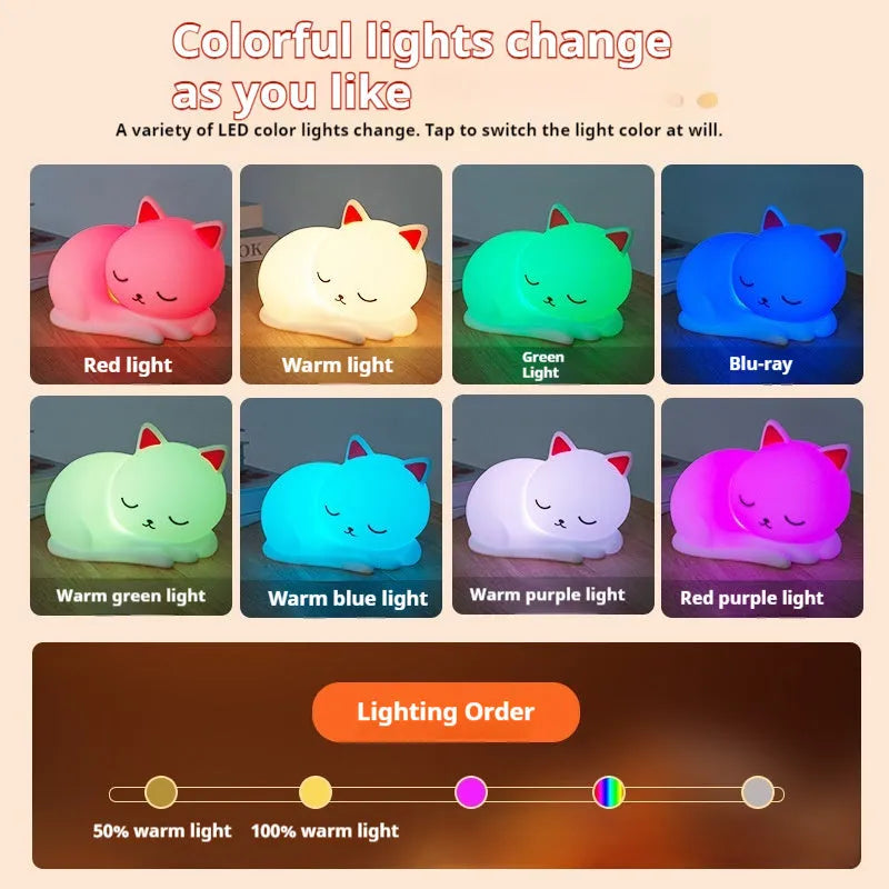Sleepy cat silicone night light with warm white glow, induction pat feature, on a bedside table