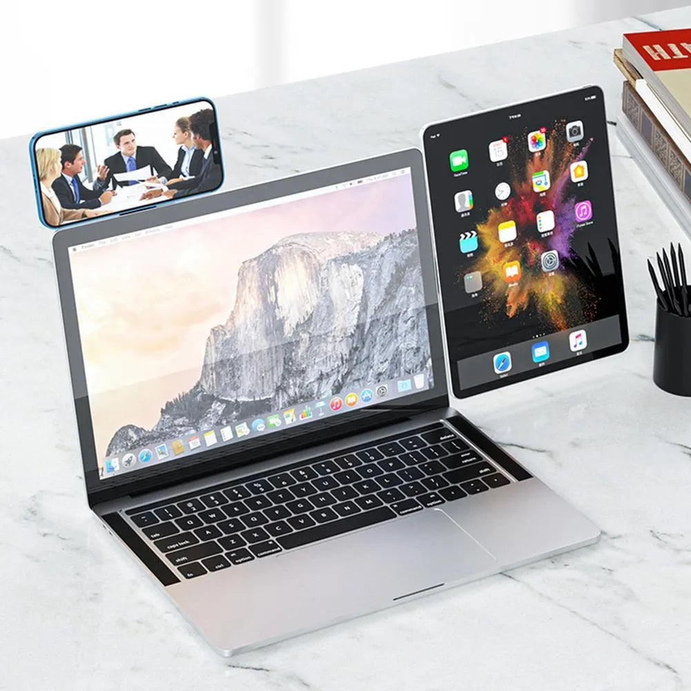 Black aluminium laptop phone holder with magnetic clip mounted to side of monitor