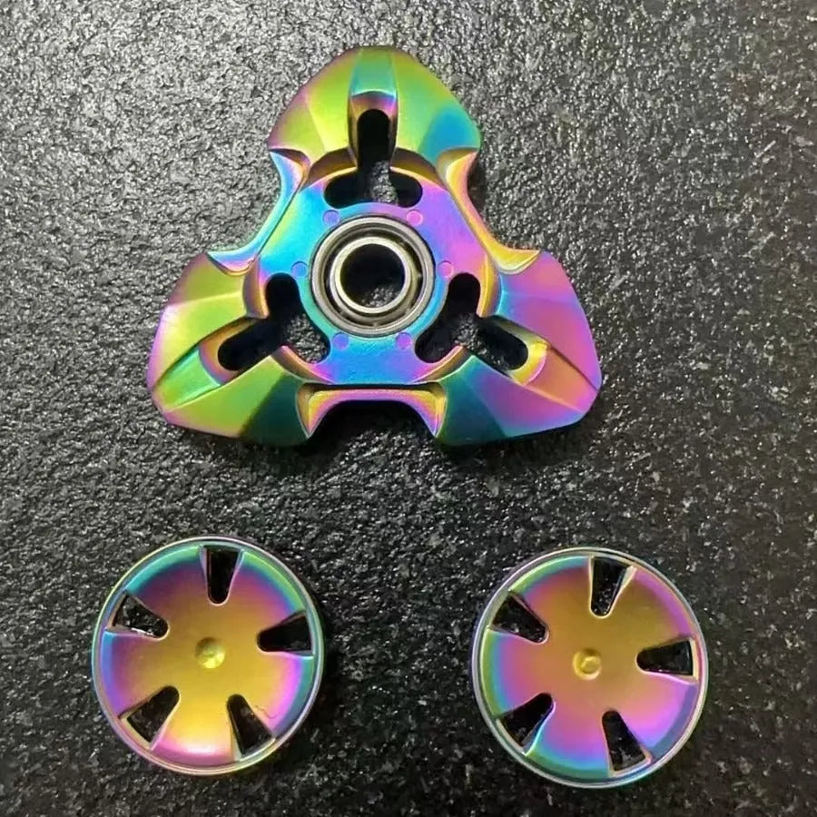 Close-up of a metallic alloy rotating fingertip gyro decompression toy on a table.