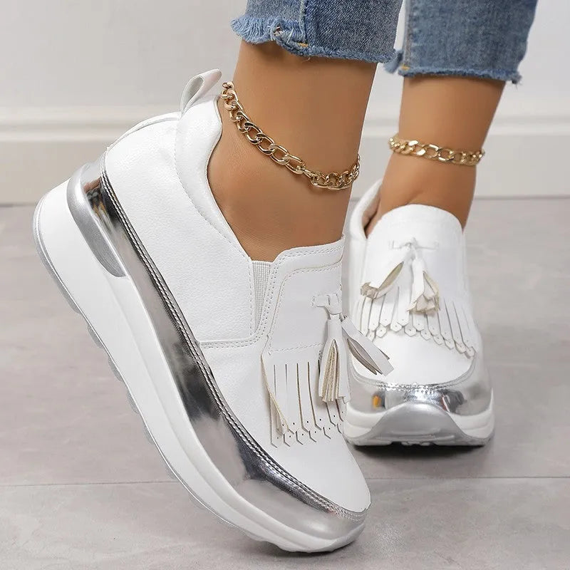 Women's black platform casual shoes with a tassel and a thick wedge heel.