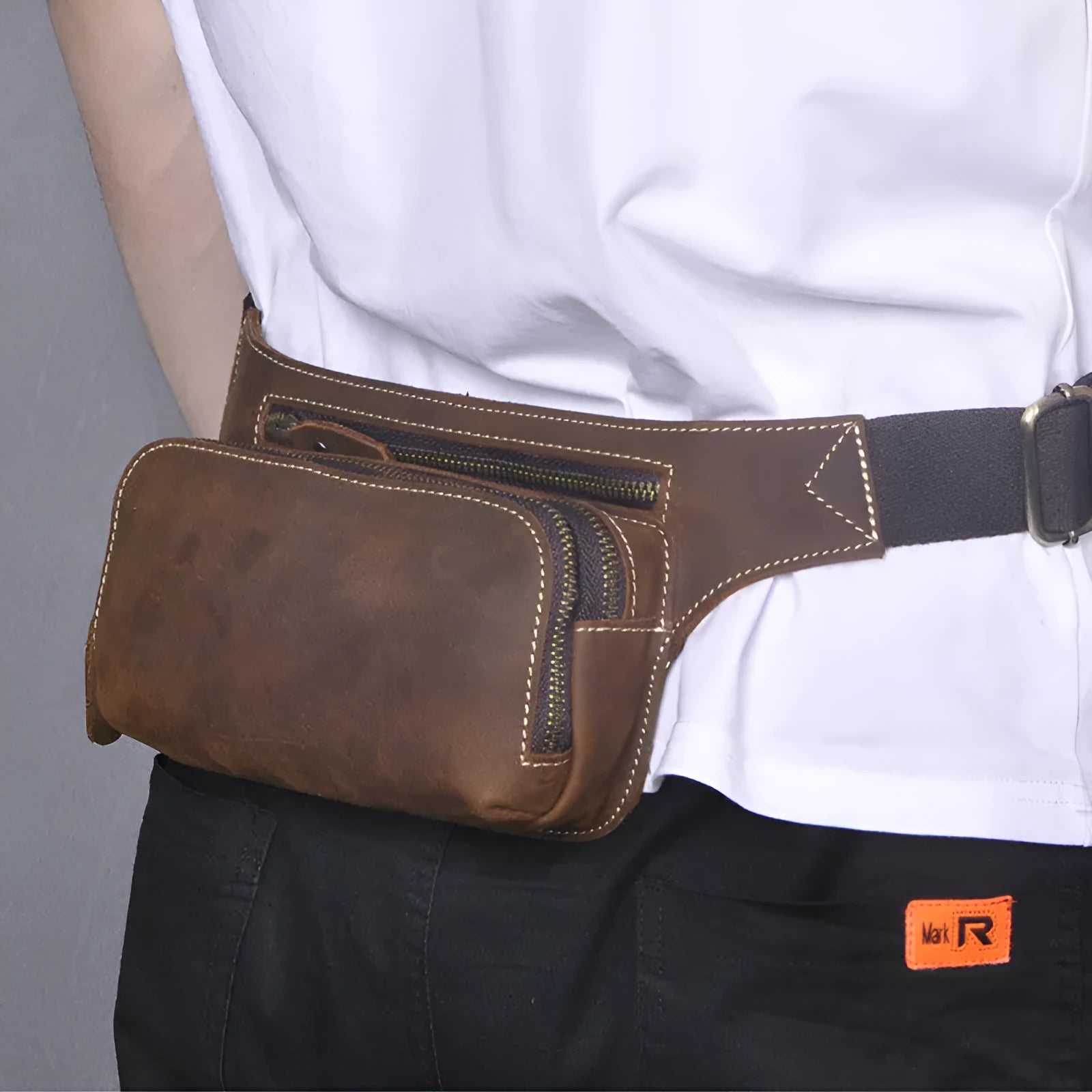 Brown genuine cowhide men's sports waist bag with pull closure showing internal mobile phone pocket