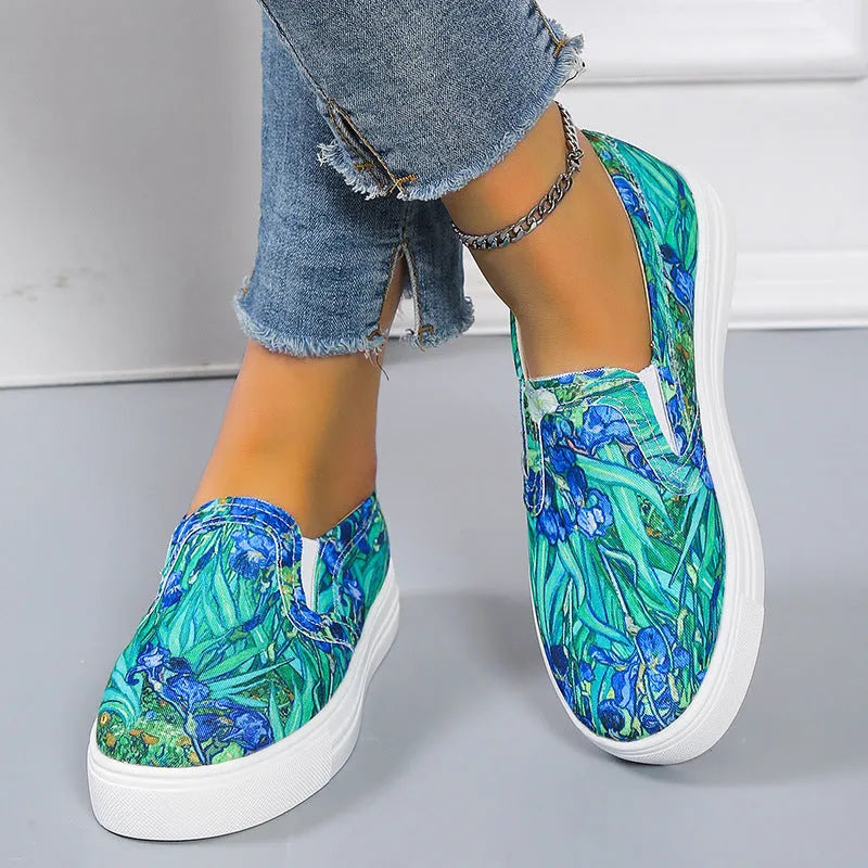 Women's low-top canvas trainers in blue, green, black and colourful designs on a flat rubber sole.