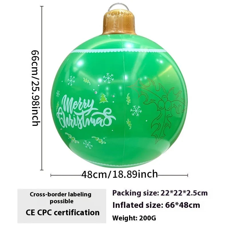 Large red inflatable Christmas ball with flashing lights displayed on a winter garden lawn.