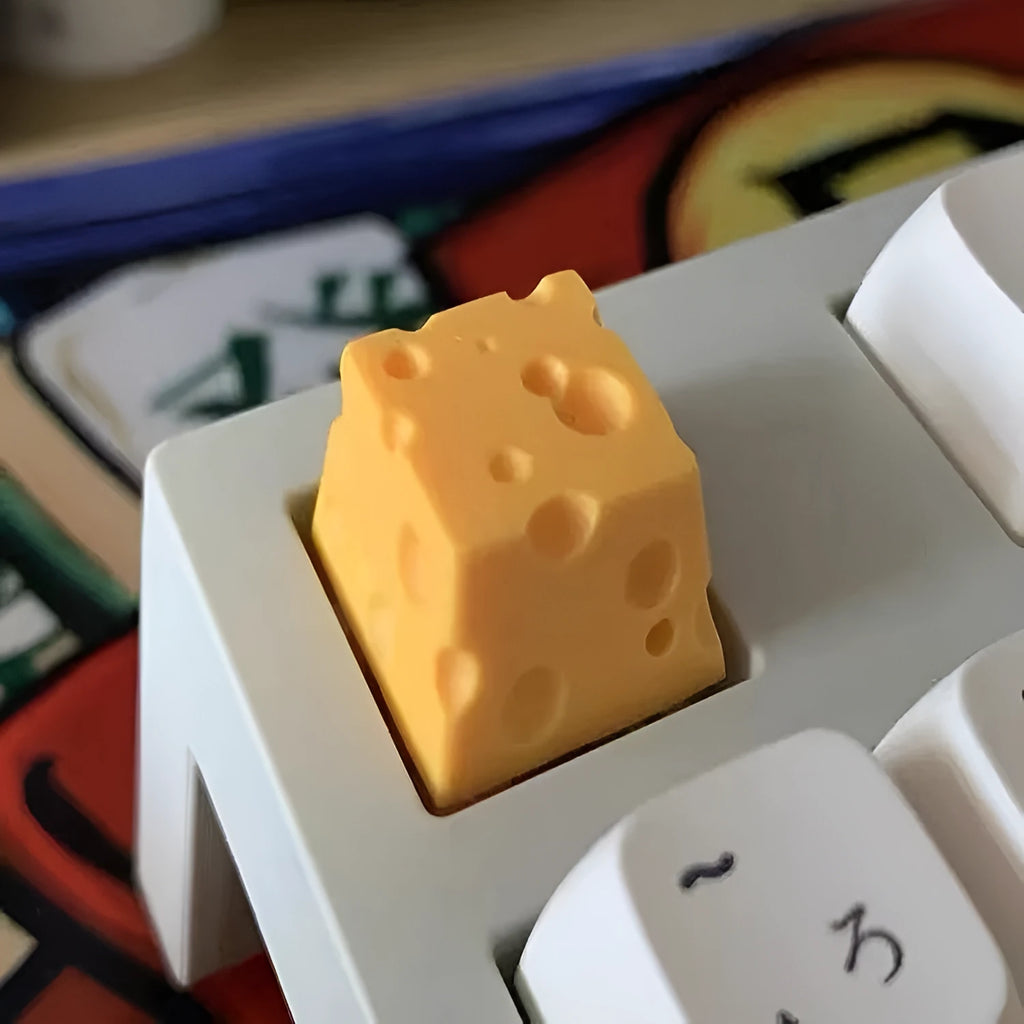 Yellow resin mechanical keyboard keycap with a detailed cheese design for MX-style switches.
