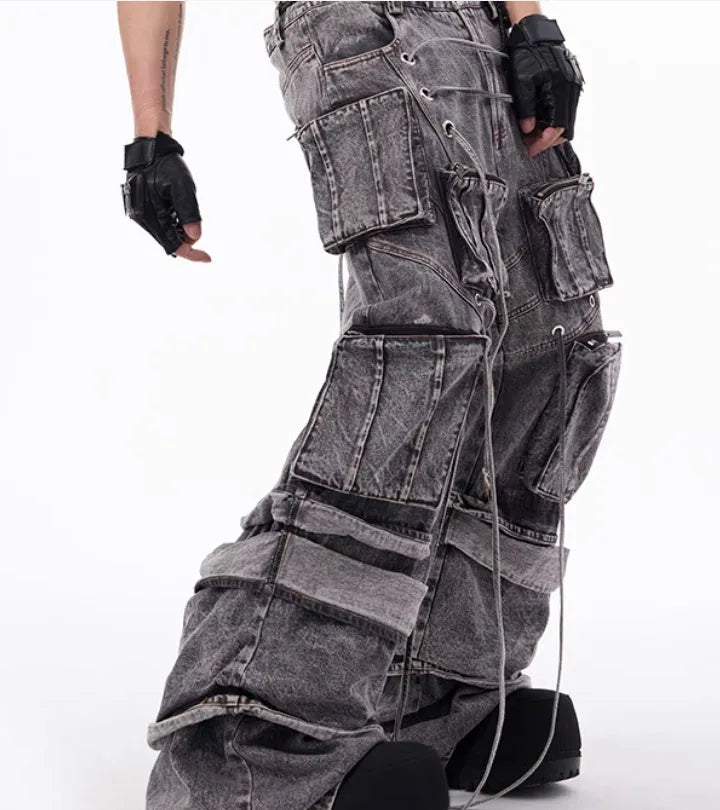 Grey distressed denim overalls with rope stitching on a hanger