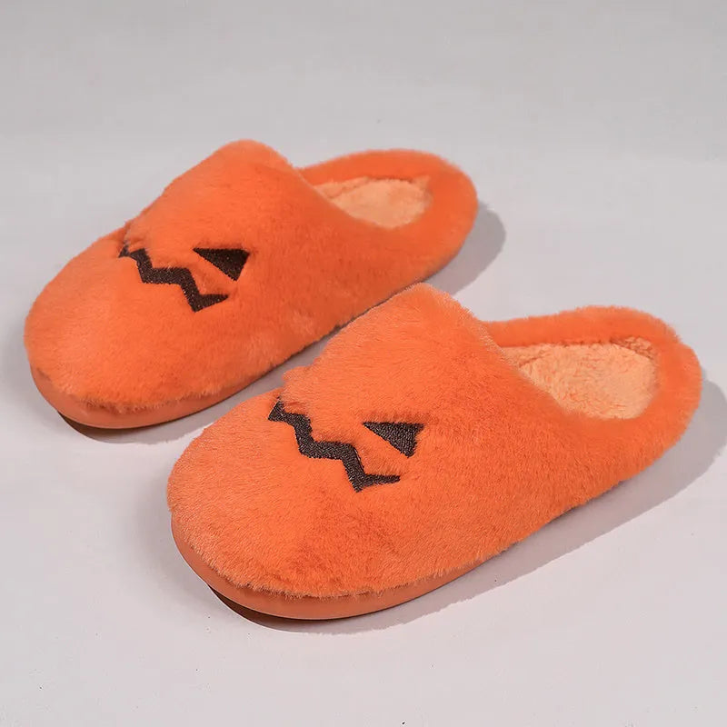 Orange pumpkin-shaped coral velvet plush slippers with a flat PVC sole.