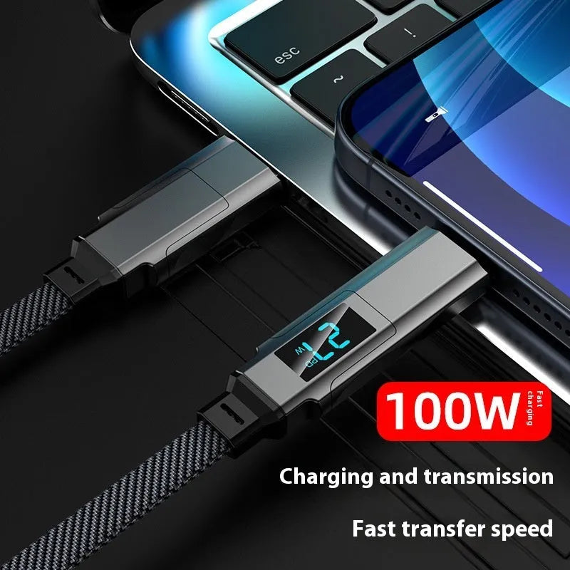 Black four-in-one charging cable with digital display and zinc alloy connectors on a surface