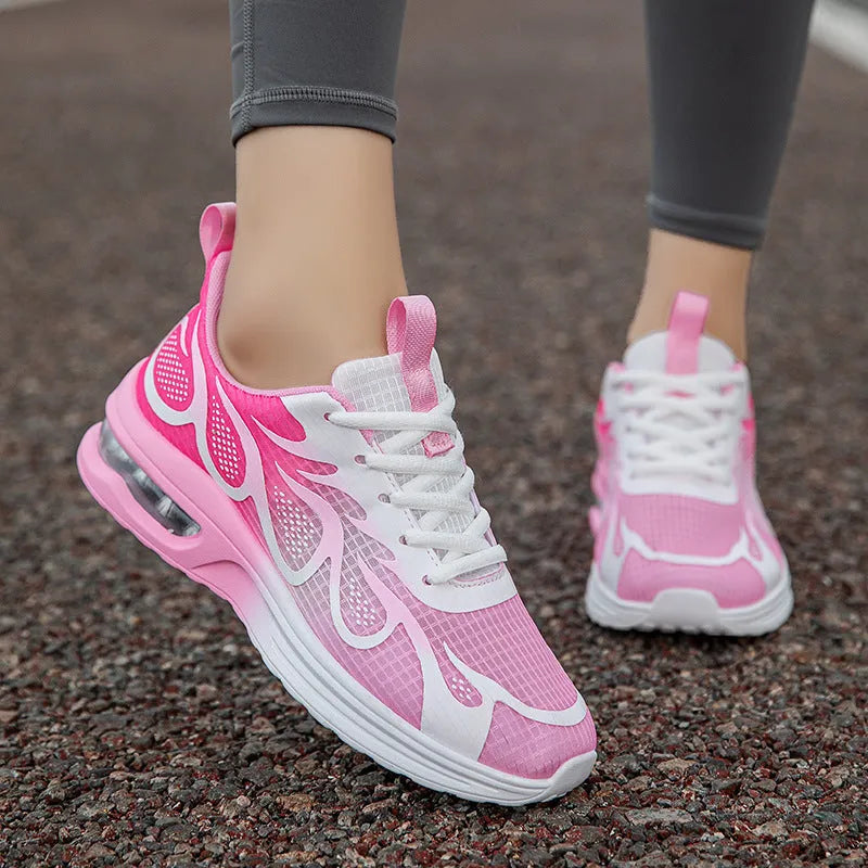 Women's pink mesh and PU sole casual sneaker shown from the side.