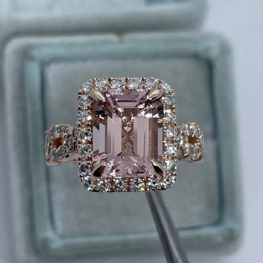 Rose gold geometric alloy ring on a plain background, showing its shape and electroplated finish.