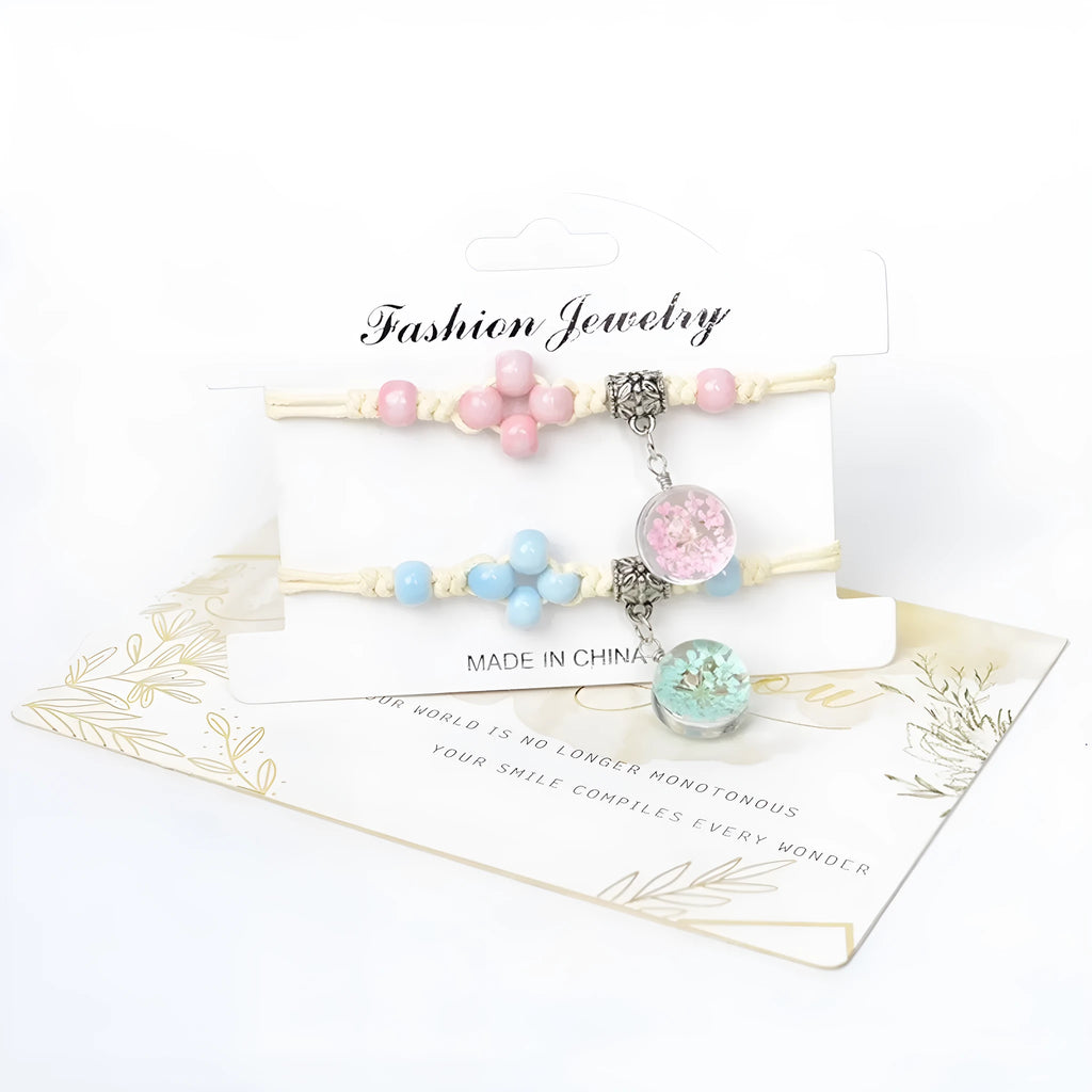 Close-up of a hand-woven glass bracelet with large 1.4cm beads containing real dried flowers in various colours.