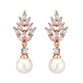 Gold, platinum, and rose gold plated geometric flower earrings with micro-inlaid zircon and pearl details.