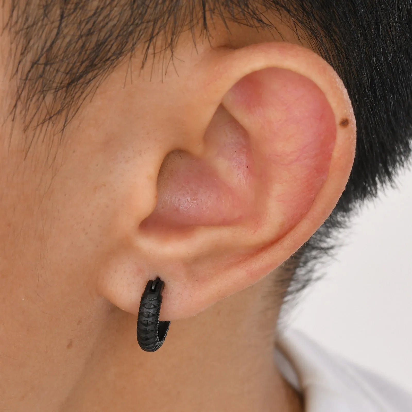 Stainless steel snake pattern earrings in black and gold finishes