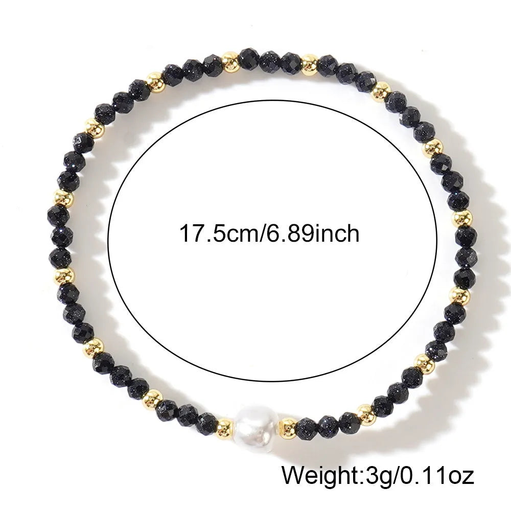 Close-up of a unisex natural stone bracelet with geometric ellipse beads on a wrist.