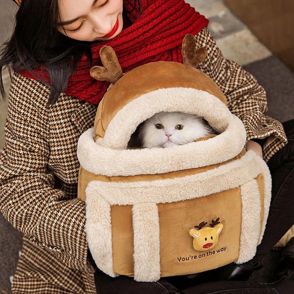 Plush reindeer dog carrier backpack with fleece lining and hand warmers for medium to large dogs