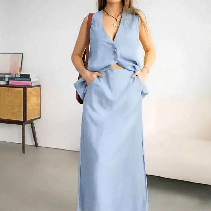 Women's white casual two-piece suit comprising a sleeveless vest and a long skirt on a hanger.