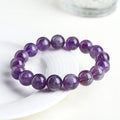 Snow Mountain feather amethyst crystal bracelet with scattered geometric beads and Ruyi element.