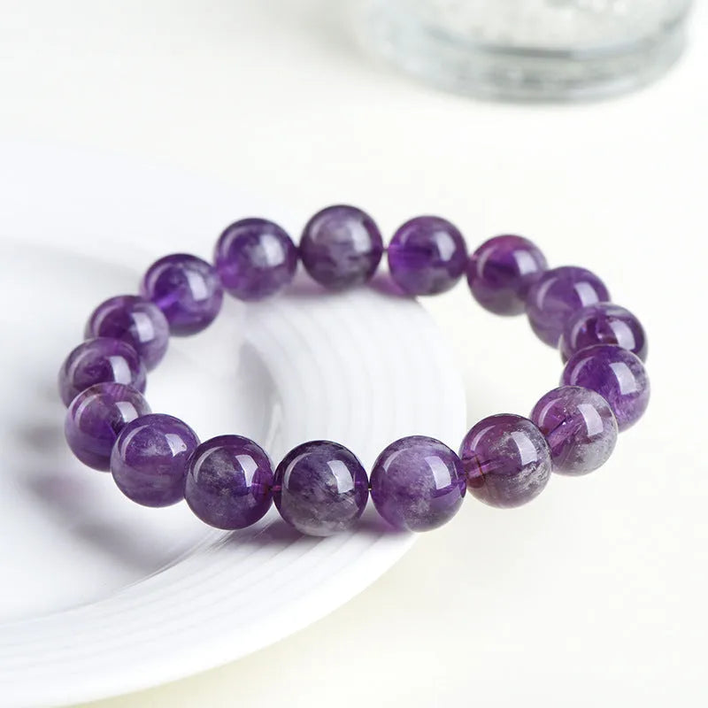 Snow Mountain feather amethyst crystal bracelet with scattered geometric beads and Ruyi element.