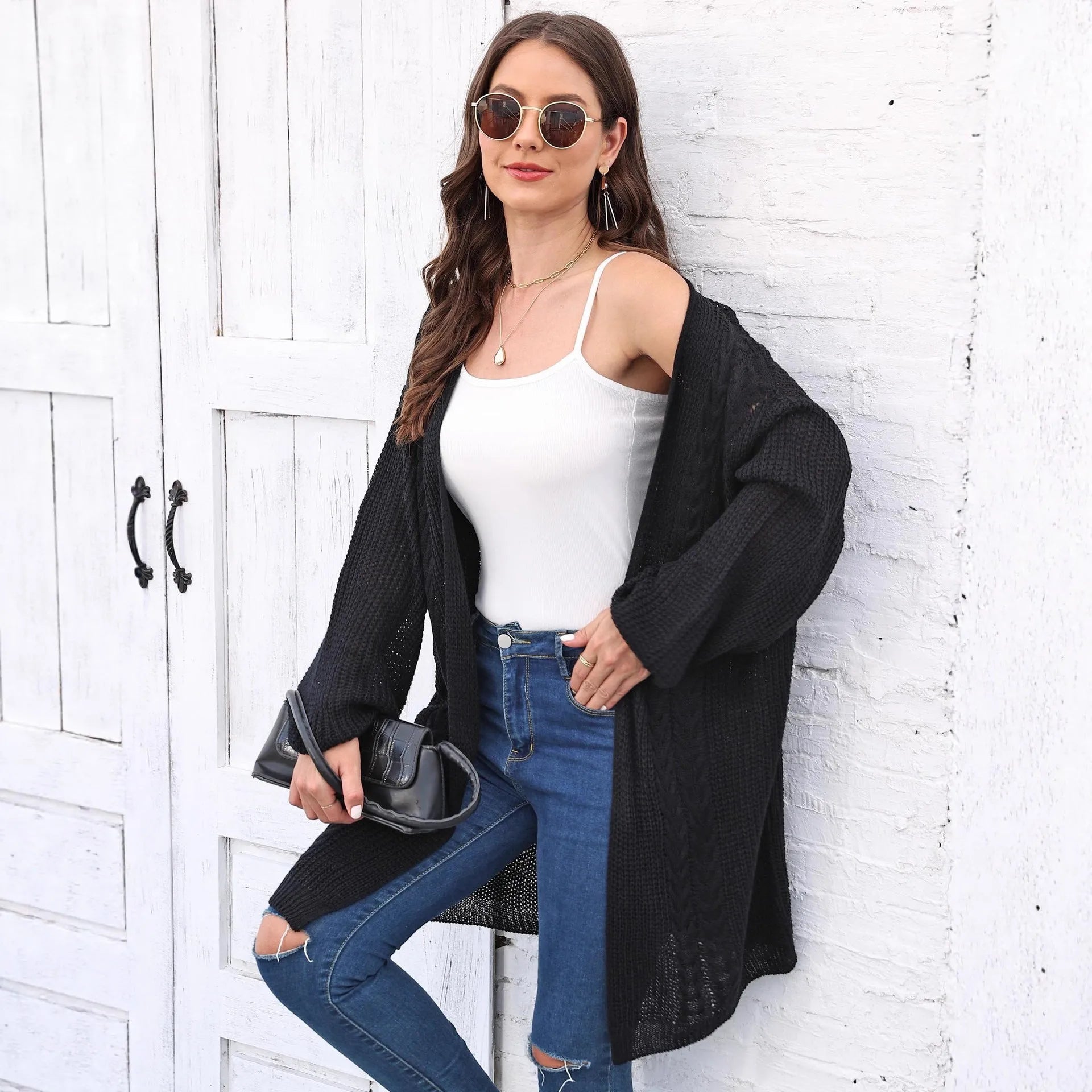 Women's loose fit acrylic sweater coat in a solid colour, shown on a hanger.