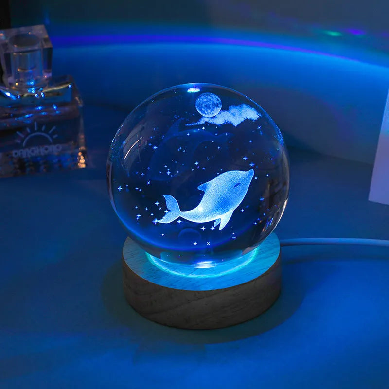 Colorful luminous crystal ball on light wooden base with data cable