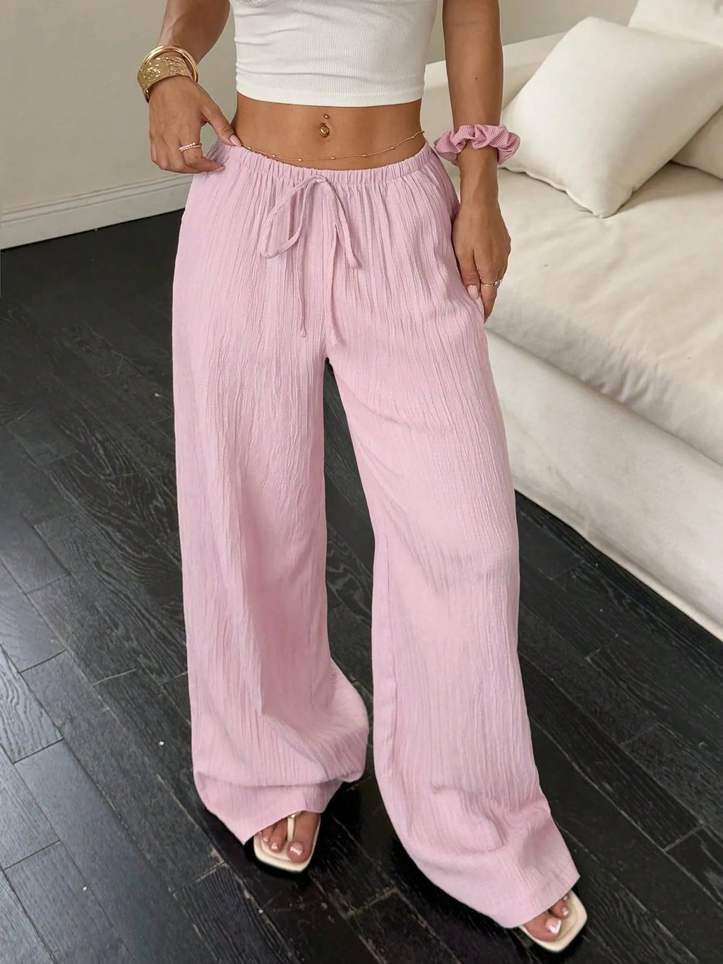 Women's black wide leg trousers with a front lace-up detail on the mid waist.