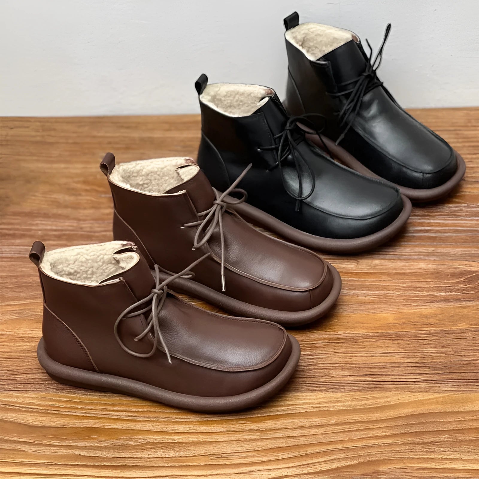 Women's black cowhide boots with a flat heel and round toe, featuring a velvet lining.