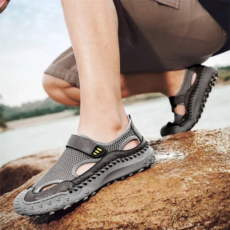 Men's black casual sandals with mesh upper and velcro straps on a rubber sole.